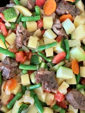 Vegetable stew with beef close up view vertical food photo. Medium diced asso Stock Photos