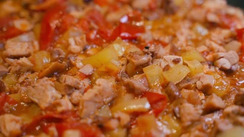 Vegetable stew with bell pepper and chicken is being prepared close-up Stock Footage 231688712