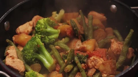Vegetable stew with chicken, stewed potatoes, green beans, and broccoli are Stock Footage 326311748