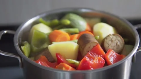 Vegetable stew of chopped eggplant and zucchini boiling in pot Stock Footage 146357459