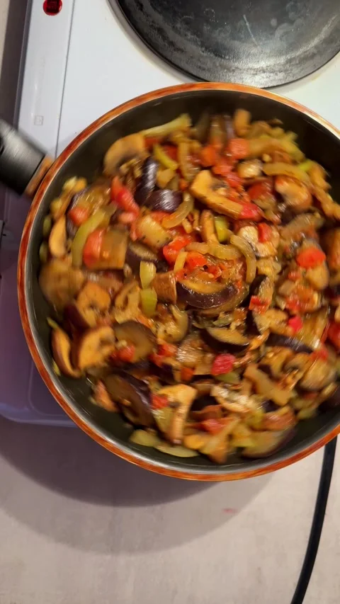 Vegetable stew cooking in a pan on stove Stock Footage 332601676