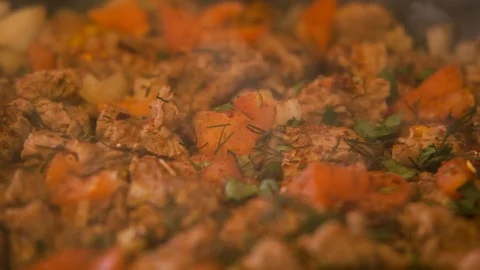 Vegetable stew with meat in frying pan,there is smoke,large frame in slow mo Stock Footage 127551876