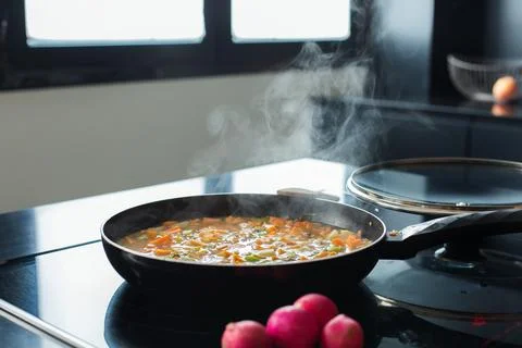 Vegetable stew in a pan at the modern kitchen Stock Photos