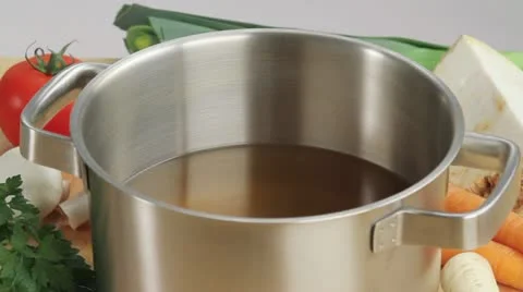 Vegetable stock in a pan surrounded by fresh vegetables Stock Footage 24667375