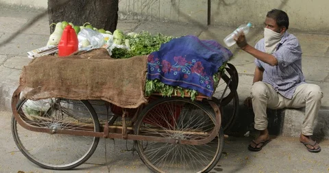 Vegetable vendor with pushcart in India Stock Footage