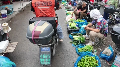 Vegetable Vendors Line a Rainy Lane at Shanghai Morning Market Stock Footage 340176807