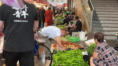 Vegetable Vendors Serve Shoppers at a Rainy Dandong Market Stock Footage 340176119