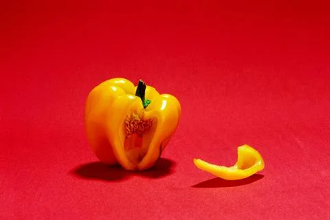 Vegetable, yellow cut capsicum with slice on red background Stock Photos