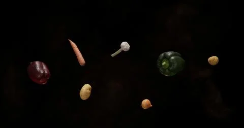 Vegetables in the air with a dark background and studio light Stock Photos