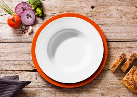 Vegetables and bread near empty bowl Stock Photos
