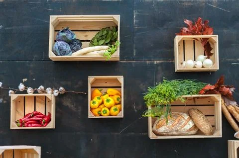 Vegetables and bread in wooden boxes. Stock Photos