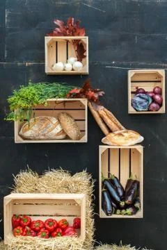 Vegetables and bread in wooden boxes. Stock Photos