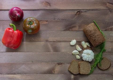 Vegetables and bread on a wooden table Stock Photos