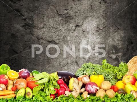 Vegetables and fruits over dark wall background. Stock Photos