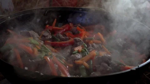 Vegetables and meat are cooked in a pan with steam Stock Footage 99515208