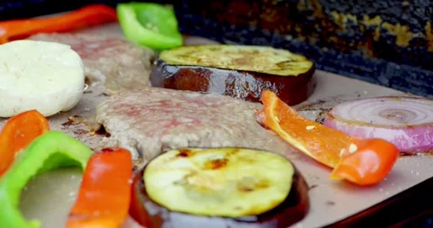 Vegetables and Meat Grilling on a Flat Top Grill Stock Footage 323334902