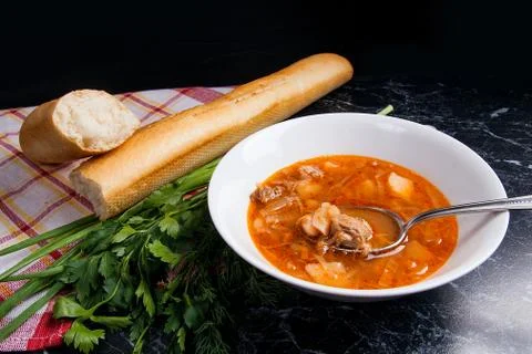 Vegetables and meat in red beetroot soup or borsch in white plate with meta.. Stock Photos