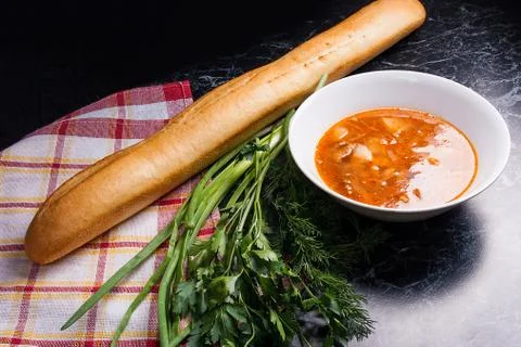 Vegetables and meat in red beetroot soup or borsch in white plate on dark m.. Stock Photos