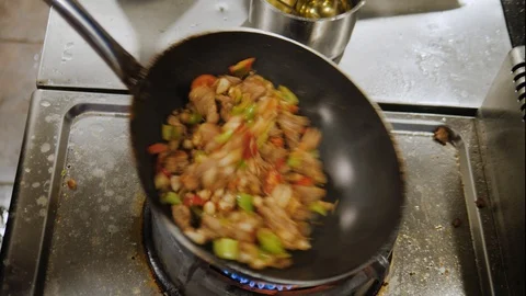 Vegetables and meat stew preparing in a pan on an open fire in restaurant Stock Footage 111460706