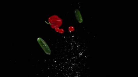Vegetables and salted on a black background take off and fall in a slowdown Stock Footage 150229653