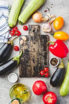 Vegetables and spices and empty cutting board Stock Photos