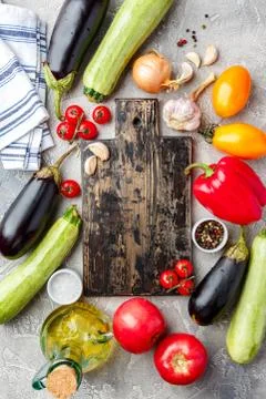 Vegetables and spices and empty cutting board Stock Photos