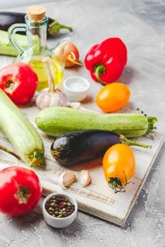 Vegetables and spices and empty cutting board Stock Photos