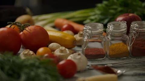 Vegetables and spices on kitchen table Stock Footage 119954481