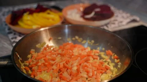 The vegetables are being fried in a pan in the kitchen. Cooking a vegetable dish Stock-Footage 313293493
