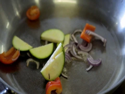 The vegetables are fried in a pan. slow motion Video stock 76055271