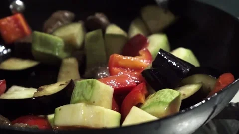Vegetables are mixed with a tablespoon during cooking. Fried meat with Stock Footage 132039268