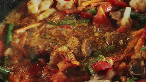 Vegetables are stewed carrots beans mushrooms in meat broth in spices bubbl.. Stock Footage 284032084