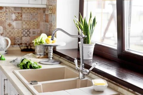 The vegetables are on the table next to the sink. Kitchen faucet, sink, kitchen Stock Photos