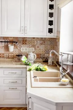 The vegetables are on the table next to the sink. Kitchen faucet, sink, kitchen Stock Photos