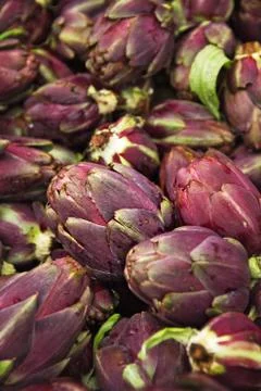 Vegetables artichokes on the counter Stock Photos