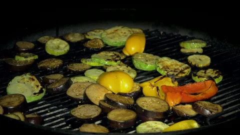 Vegetables being cooked on a hot grill. Zucchini, paprika and eggplant Stock Footage 157536505
