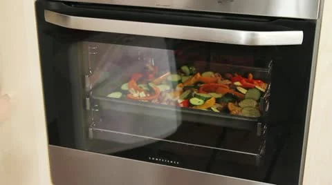 Vegetables being roasted in the oven Stock Footage 24653009