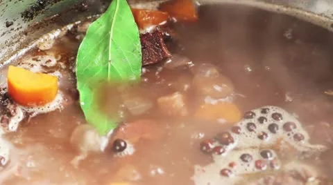 Vegetables being simmered with bones and spices (to make veal stock) Stock Footage 24673181