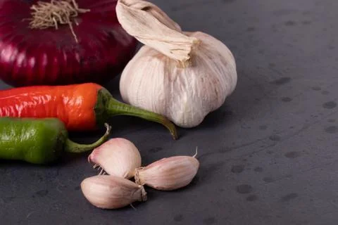 Vegetables on black stone surface Stock Photos