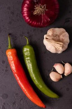 Vegetables on black stone surface Stock Photos