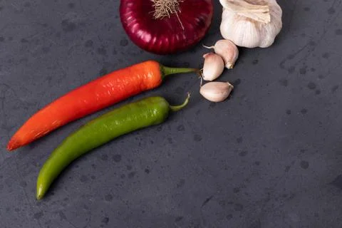 Vegetables on black stone surface Stock Photos