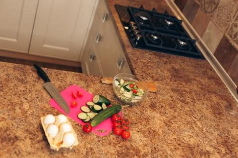 Vegetables on a board before preparing salad in the kitchen Stock Photos