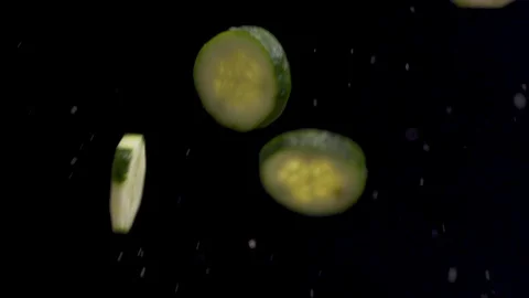 Vegetables bouncing around in a black background Stock Footage 128786467