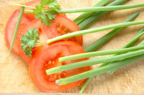 Vegetables on brown chopping board Stock Photos