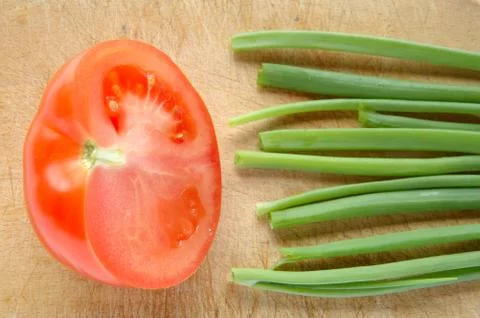 Vegetables on brown chopping board Stock Photos