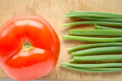 Vegetables on brown wooden chopping board Stock Photos