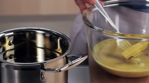 Vegetables in chickpea batter being transferred to a pot of hot oil Stock Footage 24671950