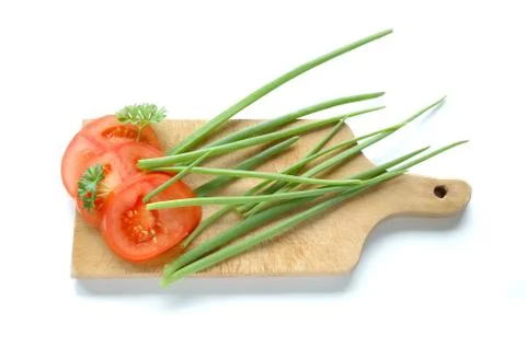 Vegetables on chopping board on white background Stock Photos