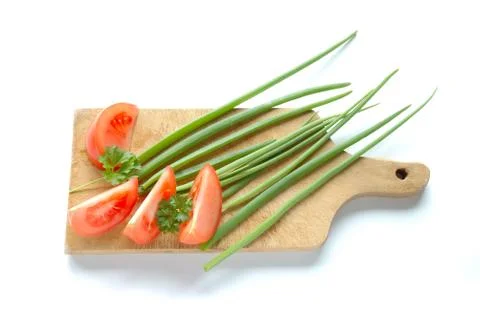 Vegetables on chopping board on white background Stock Photos