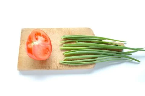 Vegetables on chopping board on white background Stock Photos